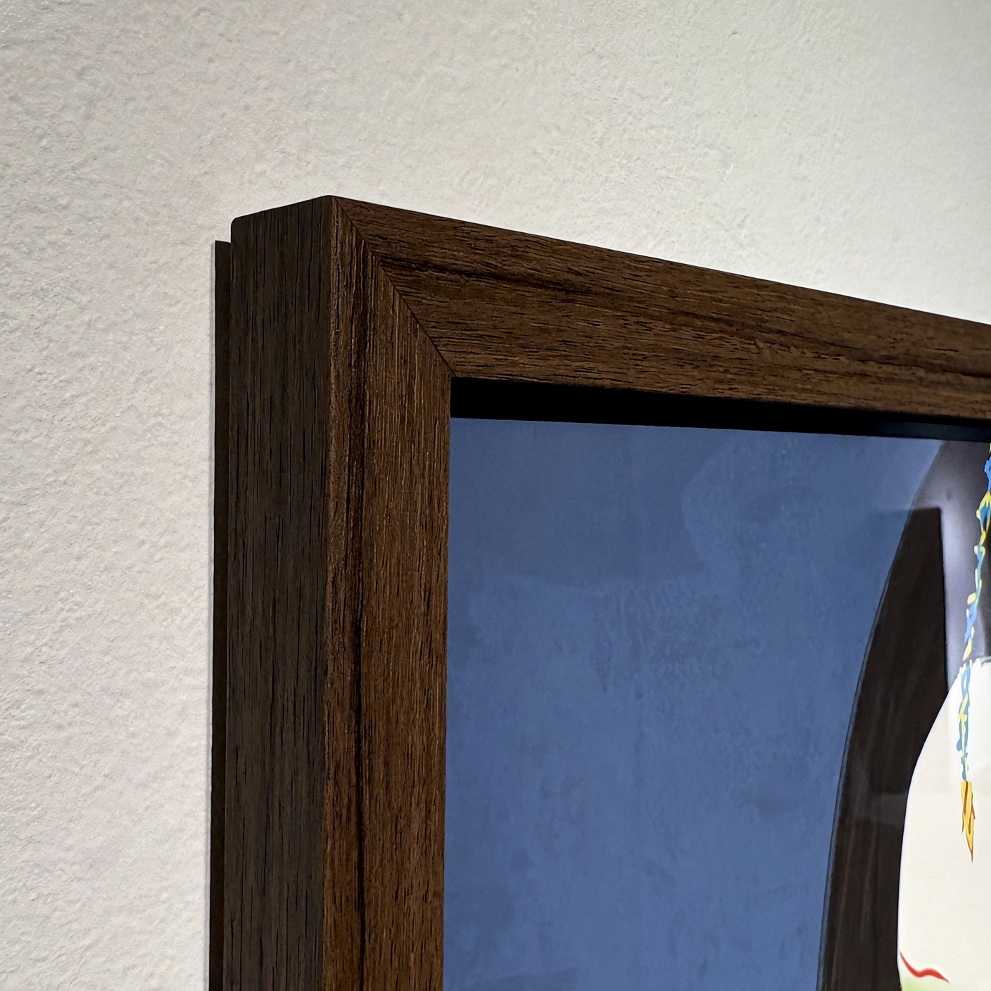The corner of the dark wood frame.