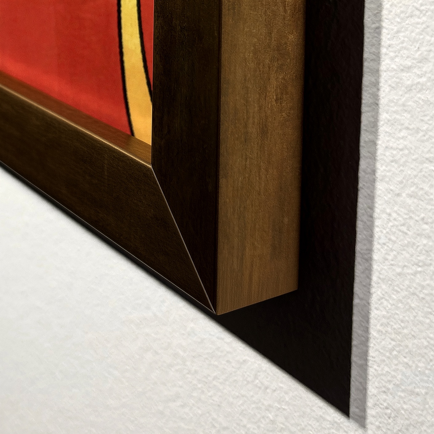 The corner of the gold frame, gilt metal over the print.